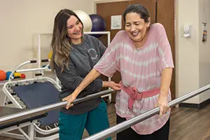 A resident doing physical therapy with a therapist at park meadows